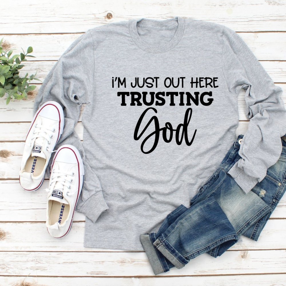 I'M JUST OUT HERE TRUSTING IN GOD LONG SLEEVE GRAPHIC TEE